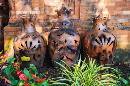 Vintage clay jugs and vases decorate the Asian garden at pagoda in summer in Asiaの写真素材