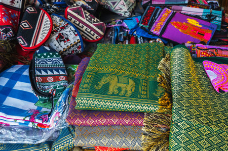 Colorful bags and various textiles on counter at a street bazaar in Vietnam in Asia
