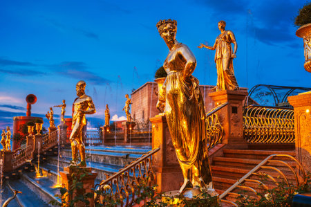 Antique golden statues on cascade of fountains in Ba Na Hills Park in Da Nang in Vietnam at eveningの写真素材