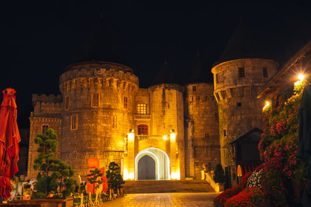 Stone medieval castle fortress in Ba Na Hills Park in Da Nang in Vietnam at nightの写真素材