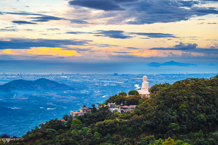 Top view of Da Nang city and Buddha statue from mountain in the Ba Na Hills in Vietnam at sunsetの写真素材