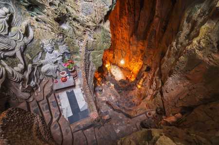 interior of deep large Am Phu cave with a Buddhist temple and sacred statues inside in Marble Mountains in Da Nang in Vietnamの写真素材
