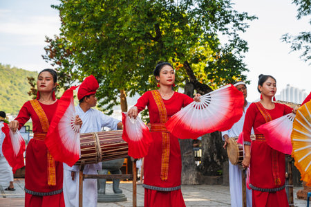 Vietnamese women in traditional festive costumes with fans dance at Po Nagar Cham Towers in Nha Trang in Asia. Nha Trang, Vietnam - August 8, 2024のeditorial素材