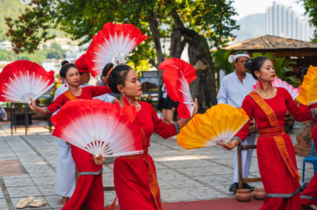 Vietnamese women in traditional festive costumes with fans dance at Po Nagar Cham Towers in Nha Trang in Asia. Nha Trang, Vietnam - August 8, 2024のeditorial素材