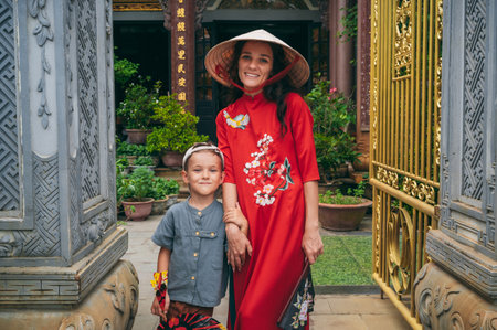 happy woman mother with boy son tourists travelers at a Buddhist temple in Vietnam in Asiaの写真素材