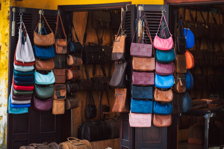 handmade leather bags, belts and accessories on counter in a shop at street market in Vietnam in Asiaの写真素材