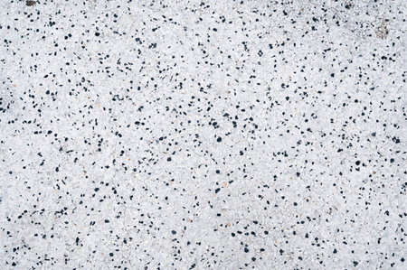 white background texture with pattern of black stones on paving slabsの写真素材