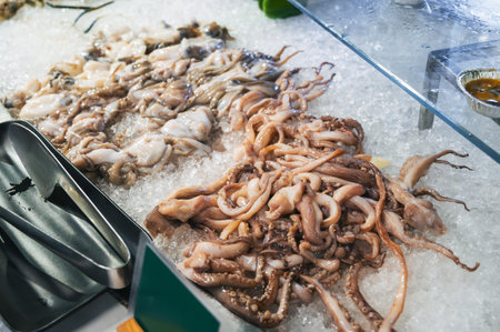 Asian seafood on display at Asian night Market in Vietnam. Fresh octopus and squid on ice