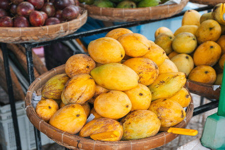 ripe yellow mangoes at Asian food market in Asia in Vietnam
