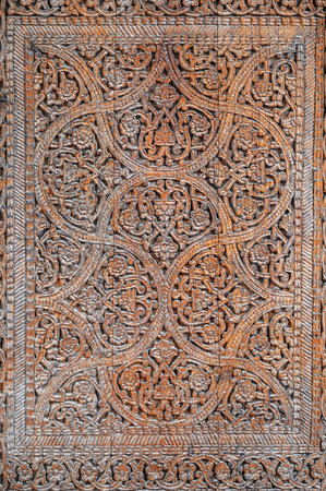 vintage traditional Uzbek carved pattern on wooden door closeupの写真素材