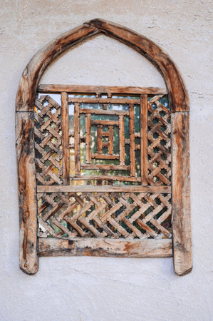 old antique Uzbek wooden window with traditional carved patternの写真素材