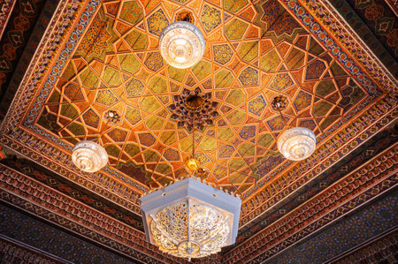beautiful carved wooden painted ceiling with an ancient chandelier in Museum of Art of Uzbekistan with traditional Uzbek ornaments and decorative oriental patterns in Uzbekistanの写真素材