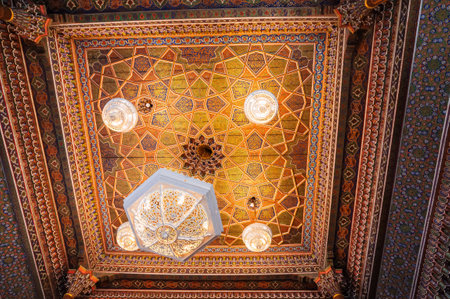 beautiful carved wooden painted ceiling with vintage chandelier in Museum of Art of Uzbekistan with traditional Uzbek ornaments and colorful oriental patternsの写真素材
