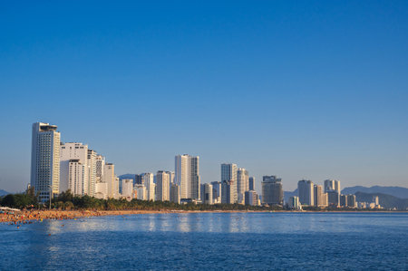 Panoramic view of resort town of Nha Trang in Vietnam with a sandy beach by the sea and skyscrapers of hotelsの写真素材