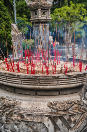 Smoking incense sticks on Buddhist pagoda close-upの写真素材
