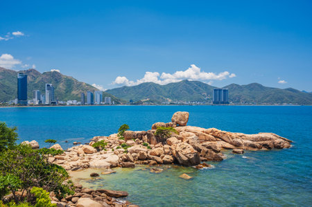 Large rocks on the background of the beach, mountains and high-rise buildings in Nha Trang. Hon Chong cape rock gardenの写真素材