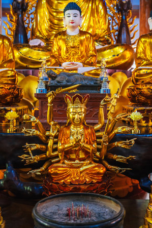 golden figurine on an altar inside a Buddhist templeの写真素材