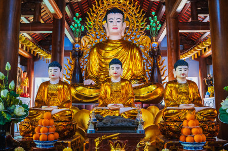 There are many Buddhist golden Buddha statues inside the interior of the Asian pagoda in Nha Trang. Vietnamの写真素材