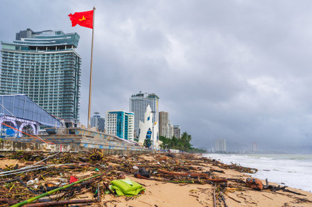 Piles of garbage and waste on the beach by sea after a storm in cloudy rainy weather. Environmental...