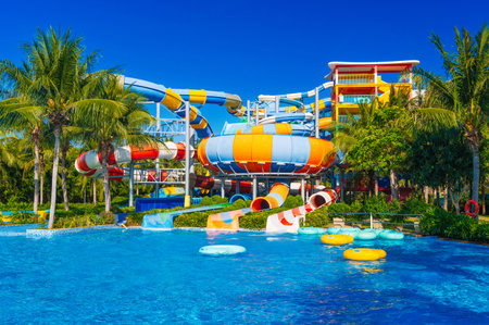 water park with slides and pipes for active extreme recreation at the resort in summer. Big colorful aquapark with a pool in the tropics