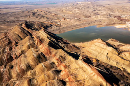 A view from above showcasing a mountain range with a lake nestled in between, illustrating the natural landscape of Georgia.の写真素材