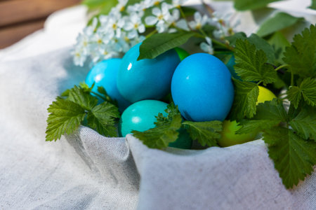 A vibrant basket contains an array of blue and green eggs, creating a beautiful display of colors.の写真素材