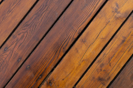 A close-up shot of diagonal wooden planks, showcasing their natural grain and texture.の写真素材