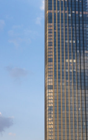 A close-up view of a modern skyscraper in Moscow, Russia, showcasing its intricate glass facade...