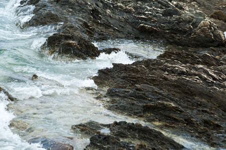 Sea waves hitting shore reef 
