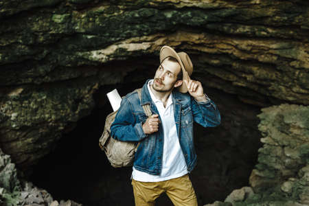 A man with a backpack in a hat is traveling