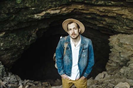 A man with a backpack in a hat is travelingの写真素材