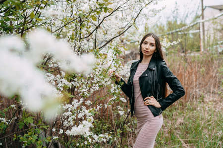 Young woman with cherry flowers portraitの写真素材