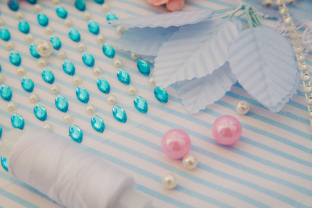 the background is a blue with handmade flowers and rhinestoneの写真素材