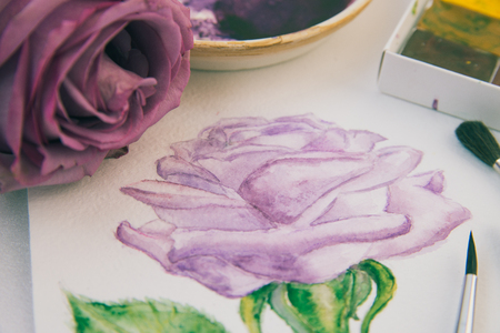 watercolor sketch of a purple rose with brushes and paintsの写真素材