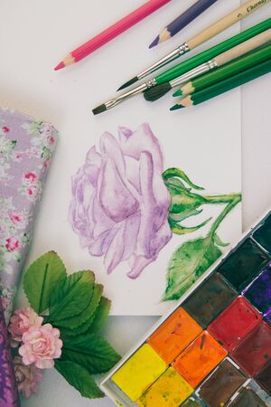watercolor sketch of a purple rose with brushes and paintsの写真素材