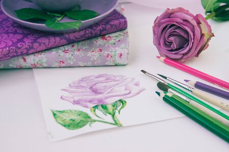 watercolor sketch of a purple rose with brushes and paintsの写真素材