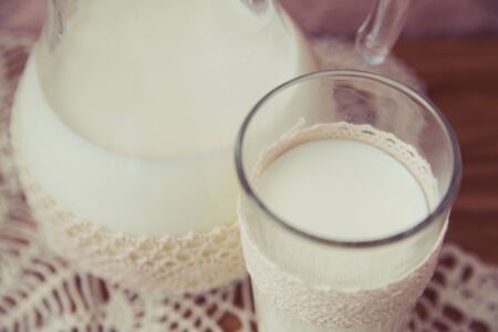 glass jar of milk on a light backgroundの写真素材