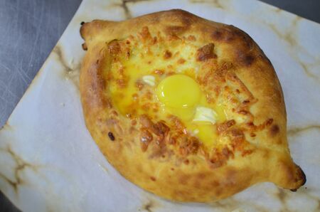 Georgian cheese-pie khachapuri with eggの写真素材