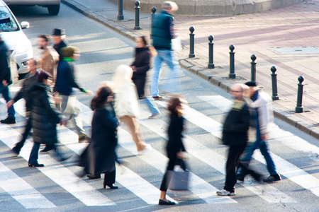 Blurry people crossing the street on zebra crossing の写真素材