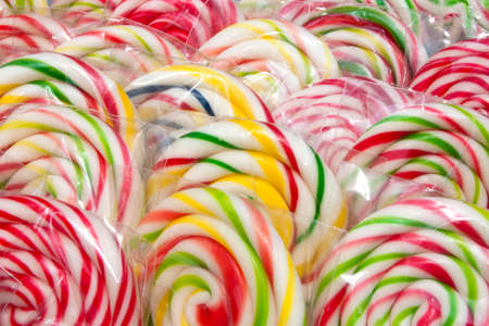 Colorful whirly lolly pops wrapped in cellophane, detailの写真素材