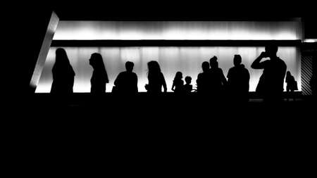 Silhouettes of young people in front of the modern building