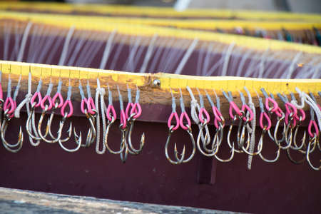 Long line fishing gear, containers with hooks inside a boat, equipment for traditional commercial fishing technique in Adriatic seaの写真素材