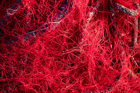 Bunch of blurry shiny red fishing net  in sunlight backgroundの写真素材