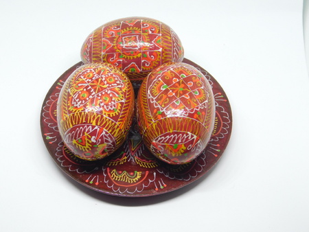 Easter wooden eggs on a plateの写真素材