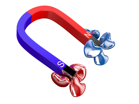 Love and attraction concept: lot of red hearts attracted by metal horseshoe magnet isolated on white backgroundの写真素材