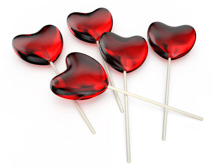 Valentine\'s Day celebration concept: red glossy shiny lolipops in the form of hearts  isolated on white backgroundの写真素材