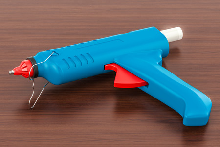 Glue Gun on the wooden table. 3D rendering の写真素材