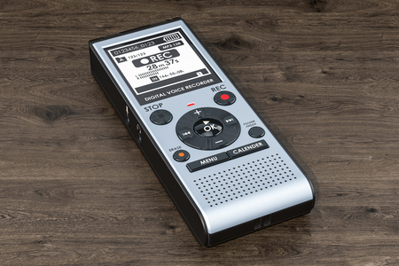 Digital voice recorder, dictaphone on the wooden table. 3D renderingの写真素材