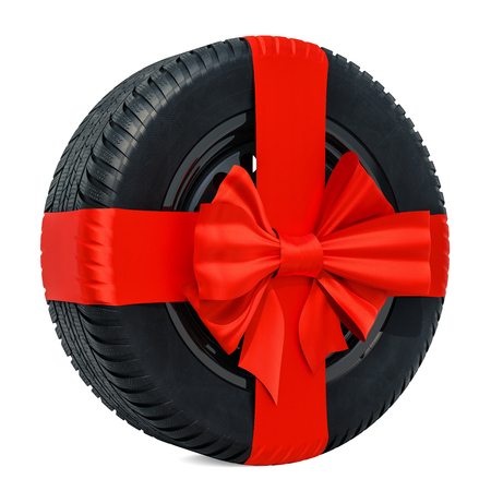 Car wheel wrapped ribbon and bow, gift concept. 3D rendering isolated on white backgroundの写真素材