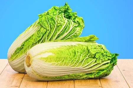 Napa cabbages close-up 3d rendering with realistic texture isolated on the wooden tableの写真素材